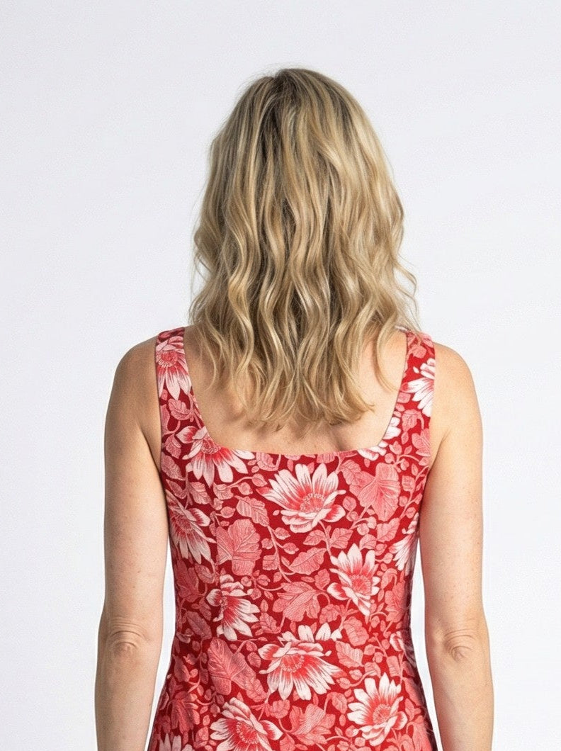 Woman wearing a red floral dress on a white background