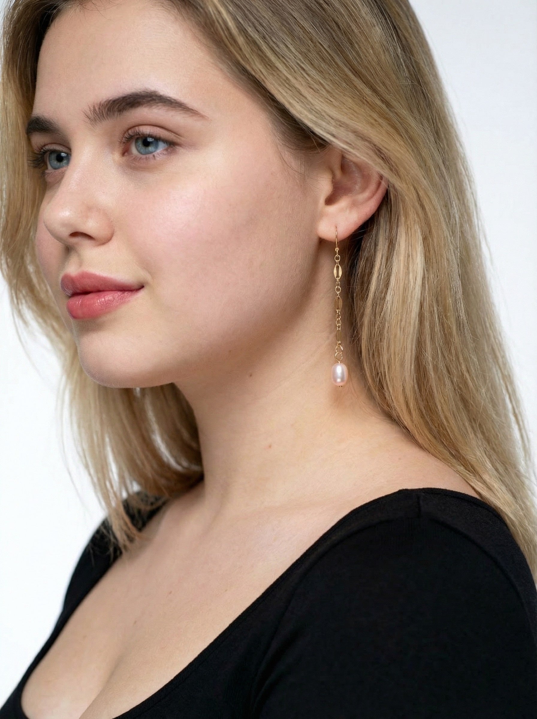 Serenade Pearl Drop Earrings on a model with blonde hair