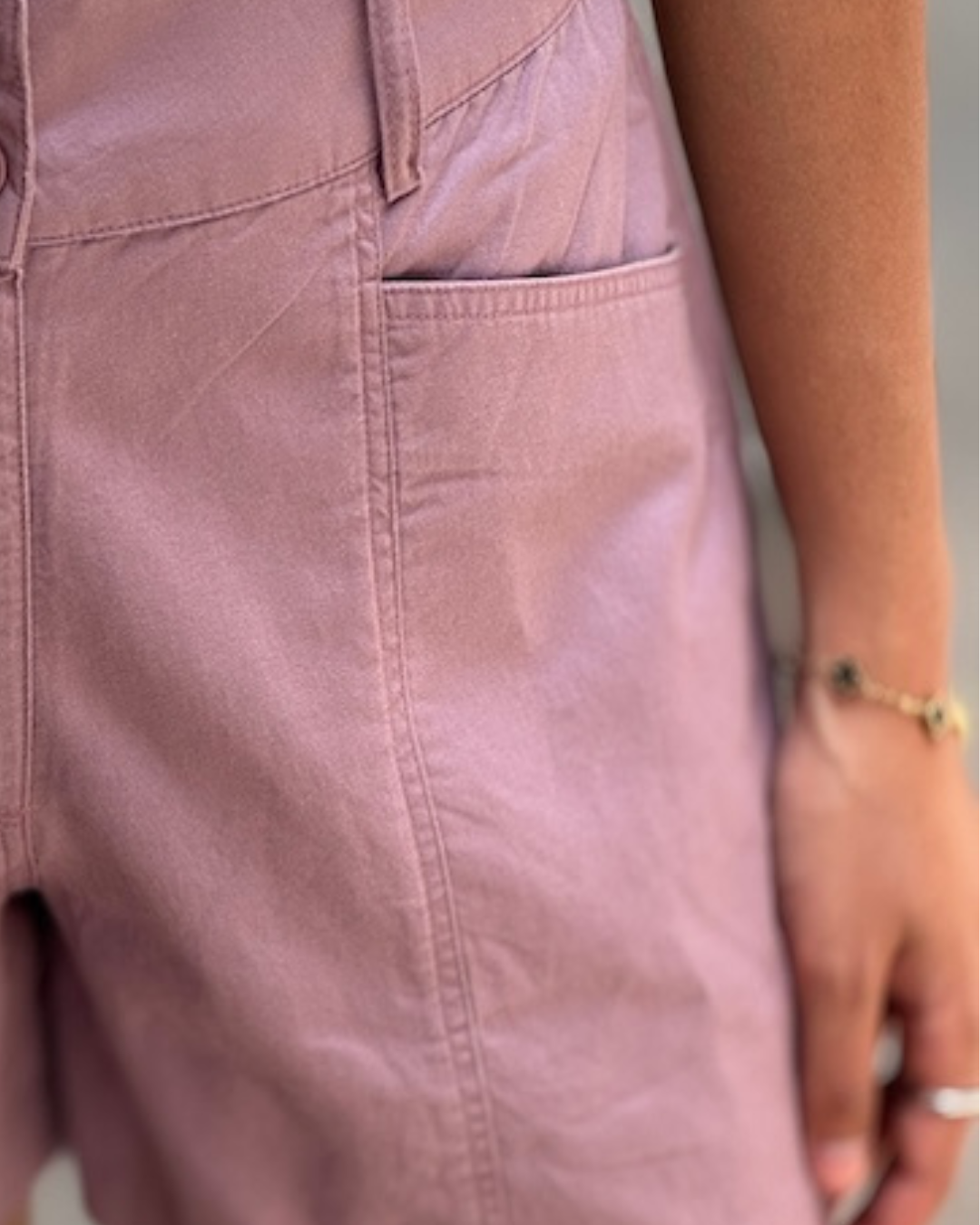 Woman in ethical fashion white t-shirt and mauve shorts, Reca clothing, studio backdrop