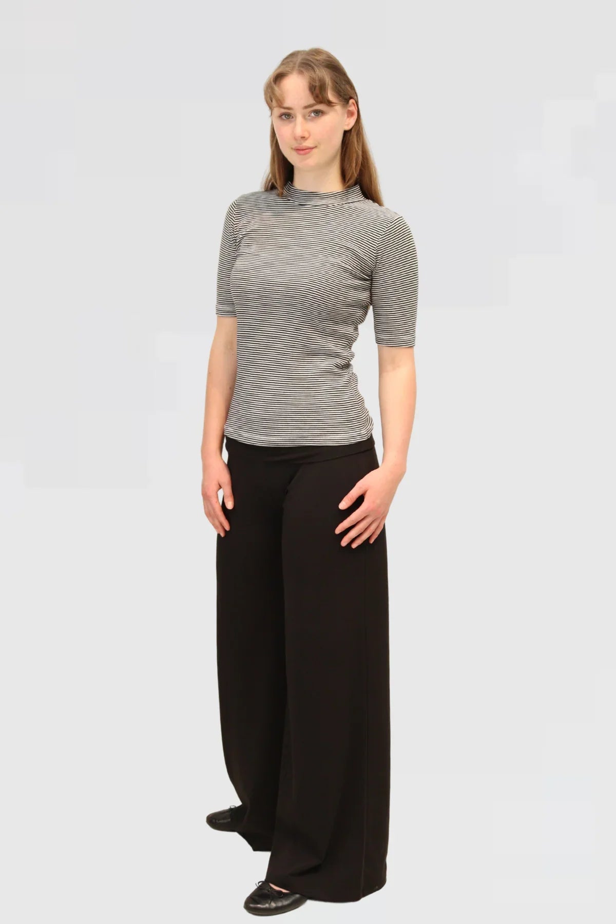 Side detail of Reca’s Leisure Lux Pants in black, highlighting the soft stretch waistband and smooth fabric finish.