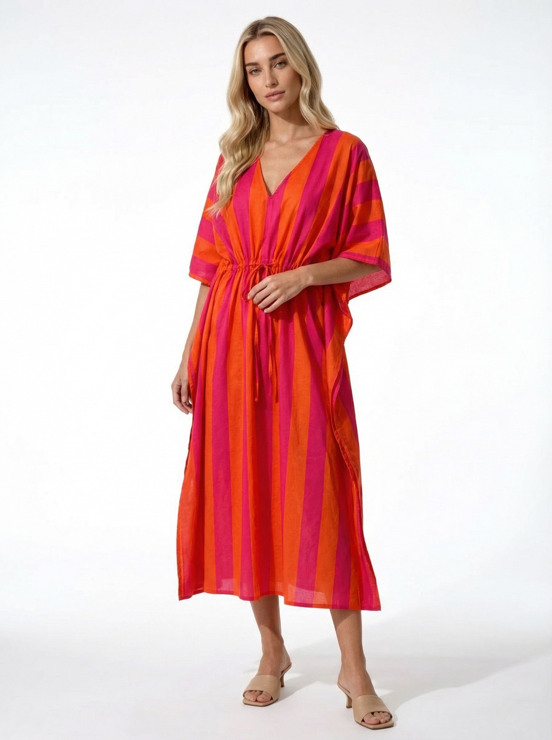 Woman wearing a vibrant Sunset Stripe Pink & Orange Kaftan on a white background