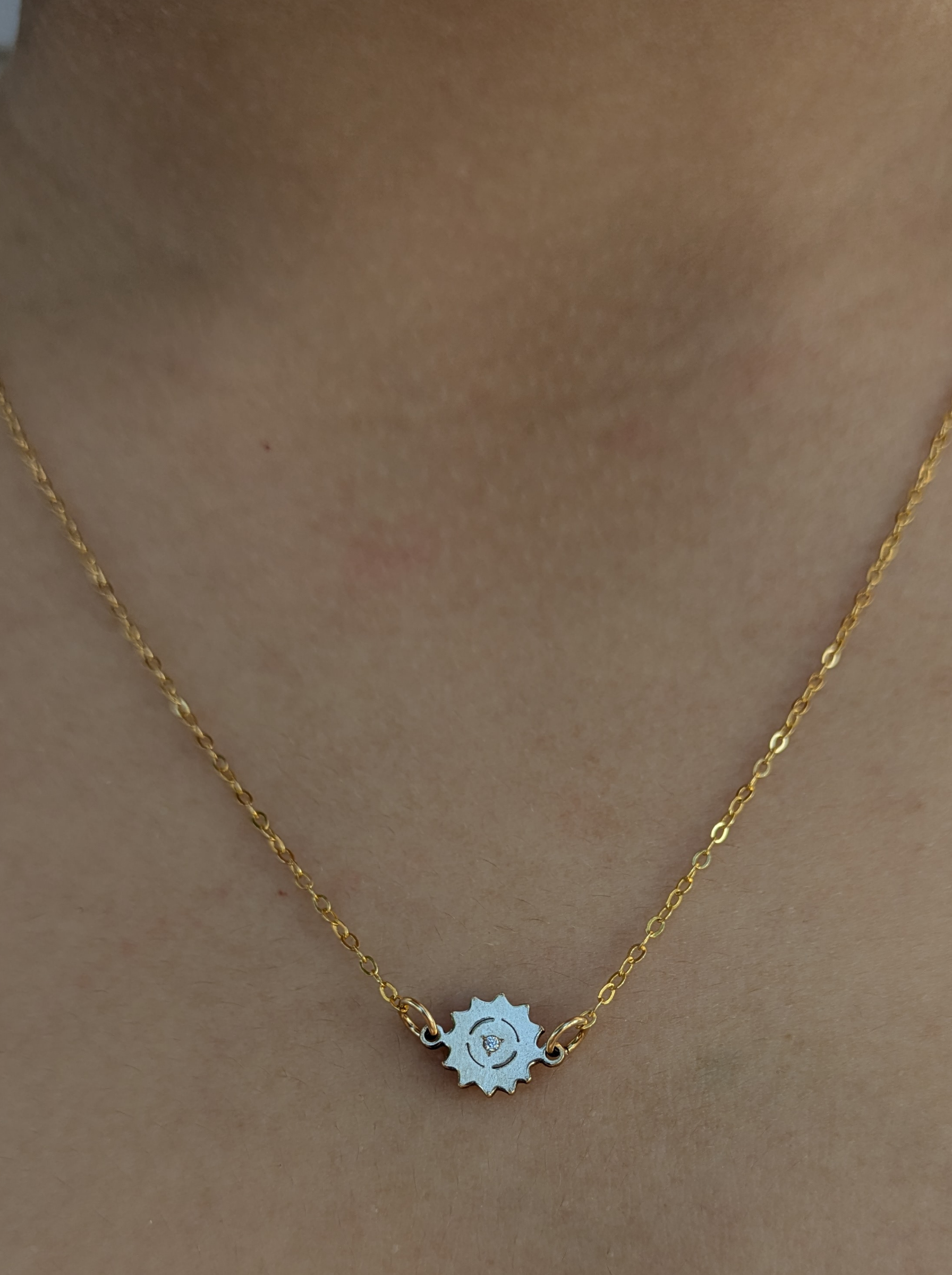 Ethical gold chain necklace with sun-shaped pendant on model, Reca jewelry