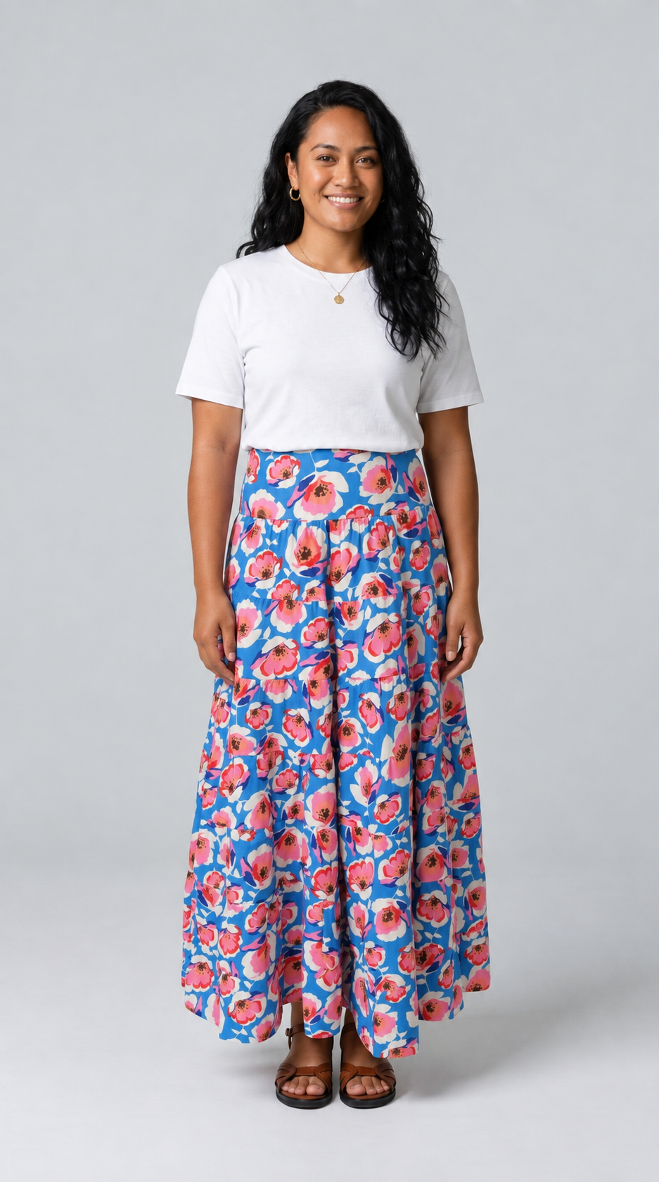 Woman wearing the Reca Azure Poppy Maxi Skirt in blue floral cotton, front view