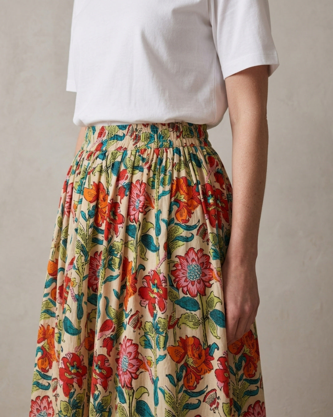 Side view of the Bloomfield Garden Skirt in 100% cotton, showing soft gathers falling from the elasticated waist to the midi hem