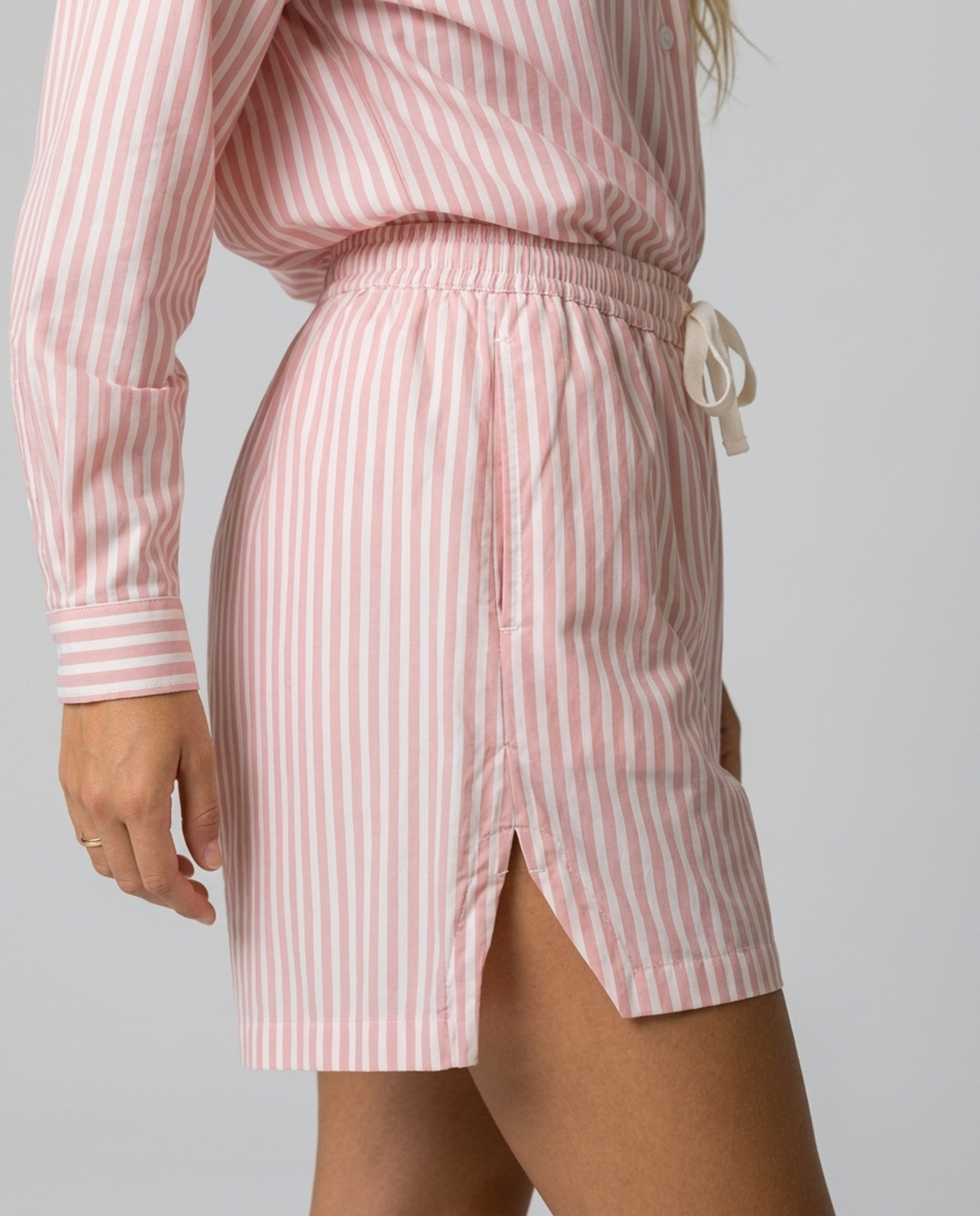 Blush Pink Stripe Cotton Shorts – close-up side view showing pink stripes and split hem