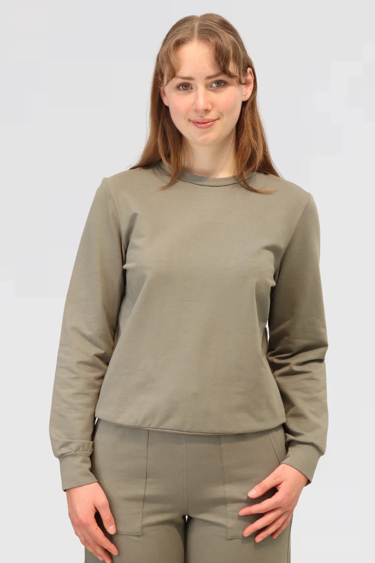 Close-up of Agave Drape Trousers paired with Organic Cotton Sweater, highlighting waist and drape detail.