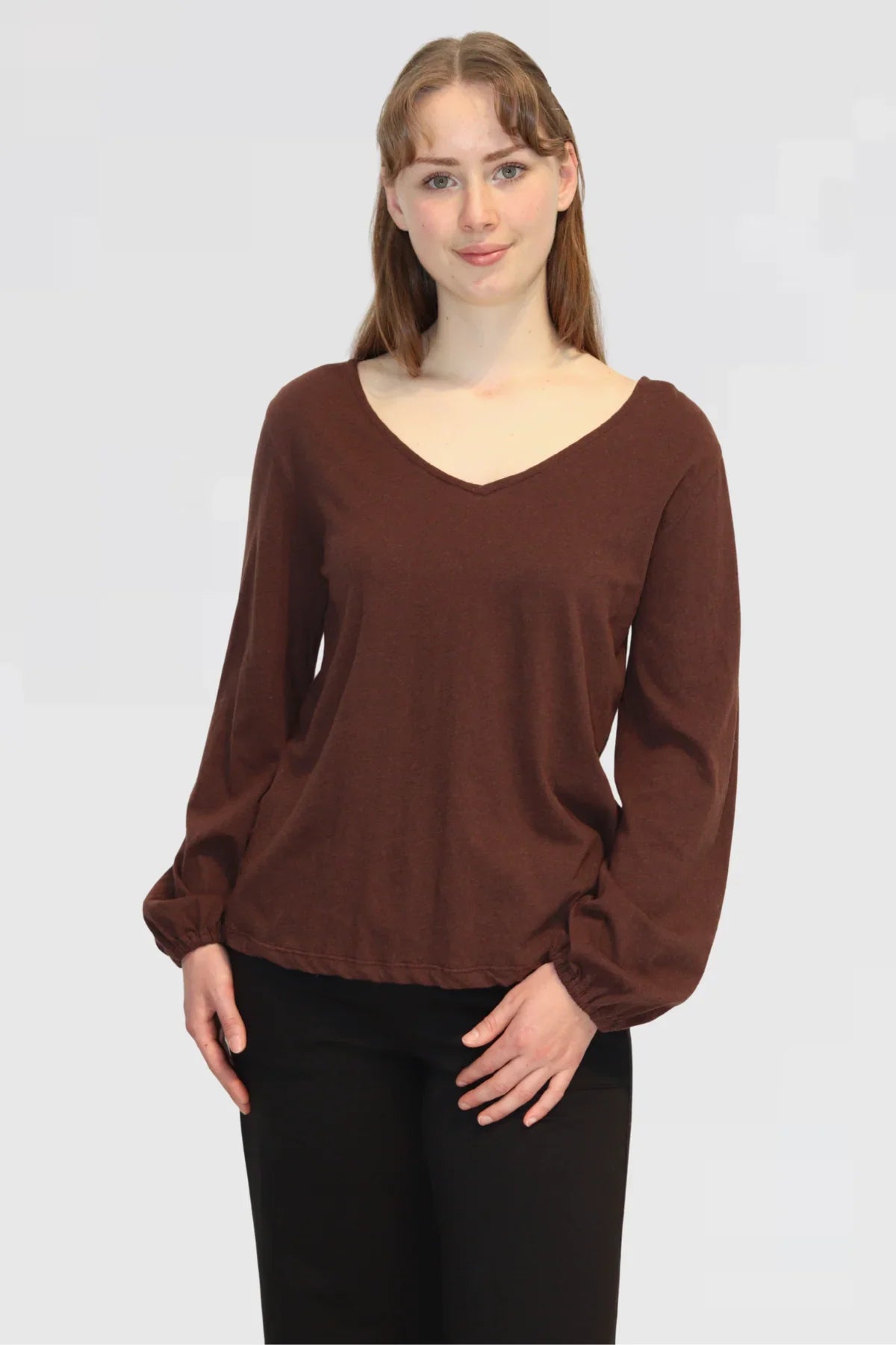 Close-up of Bishop Blouse in Redwood, showing V-neckline and soft drape of fabric.