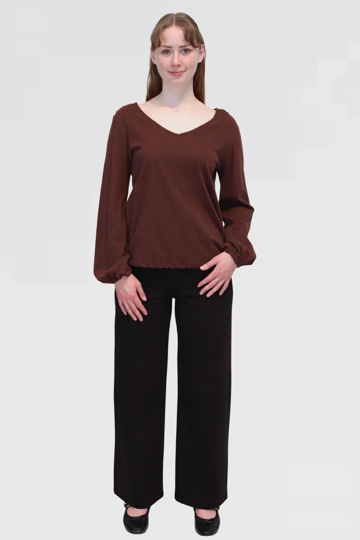 Front view of Reca Bishop Blouse in Redwood, featuring V-neckline and long bishop sleeves with gathered cuffs.