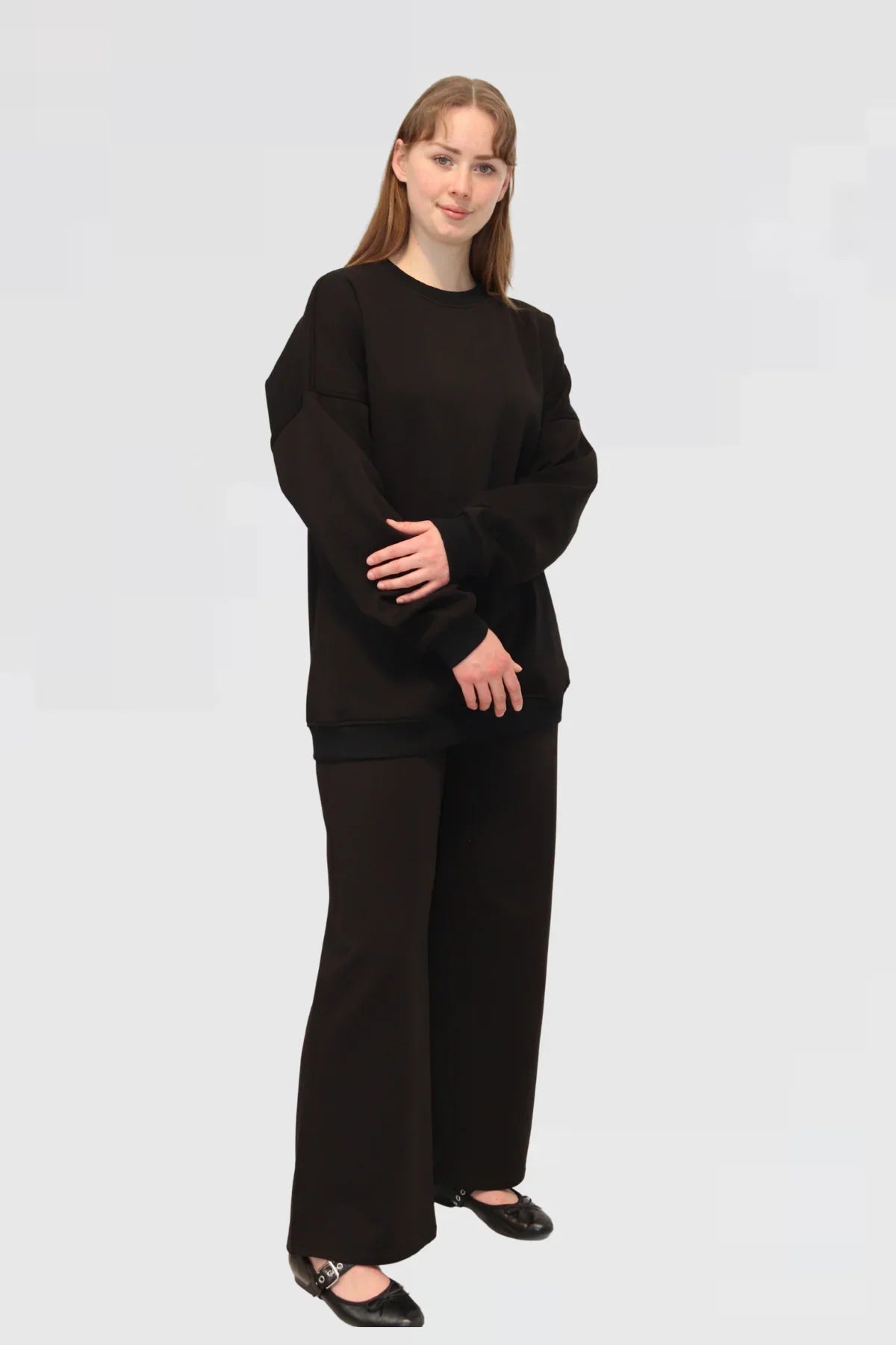 Model wearing Ranch Drop Sleeve Jumper in Black, angled front view highlighting relaxed silhouette.