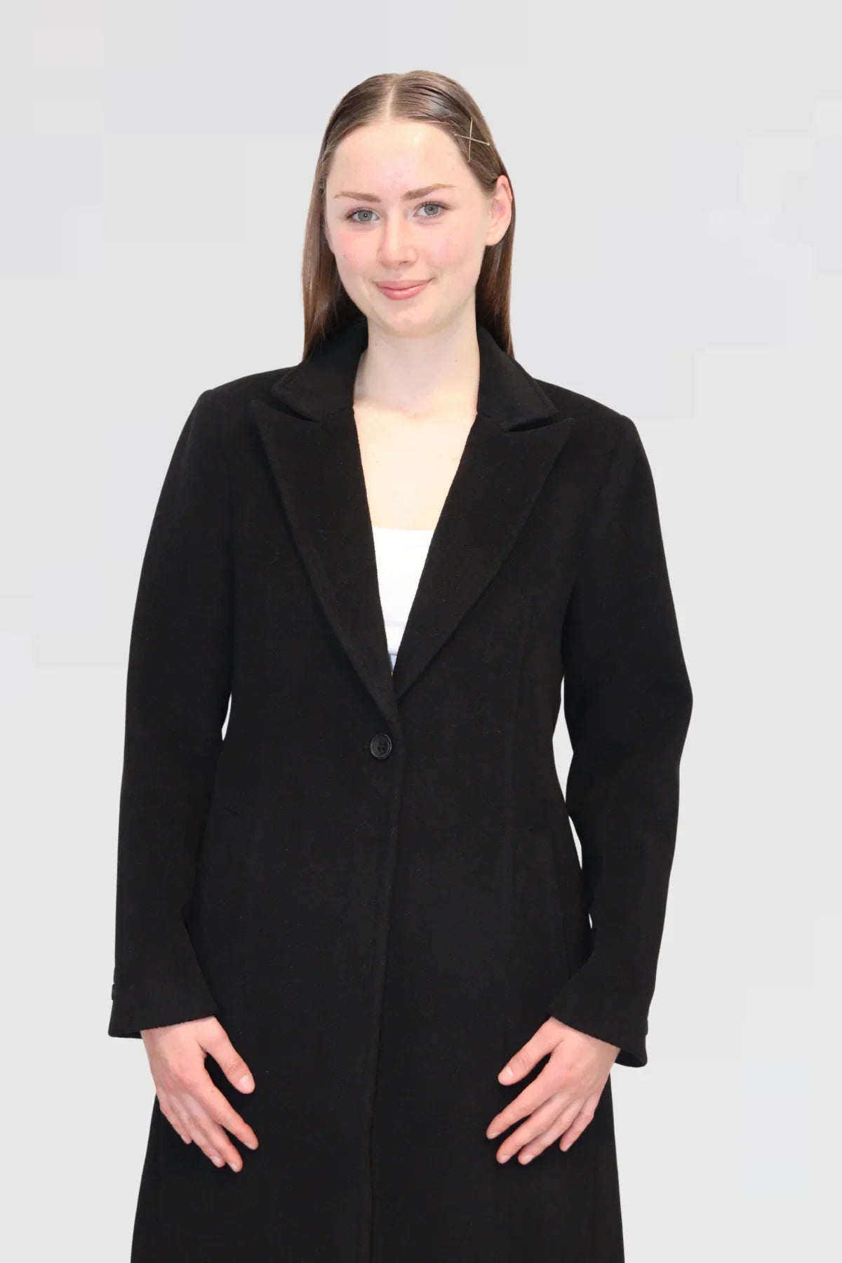 Close-up of Single-Button Wool Coat in Black, tailored lapel and front button detail.