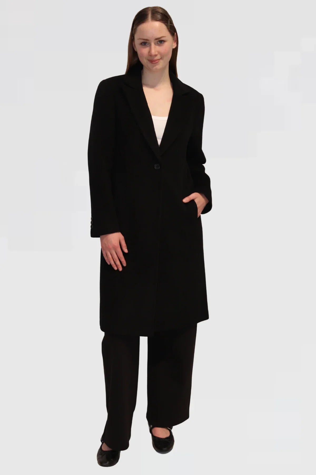 Model wearing Single-Button Wool Coat in Black, angled front view highlighting tailored fit and pockets.