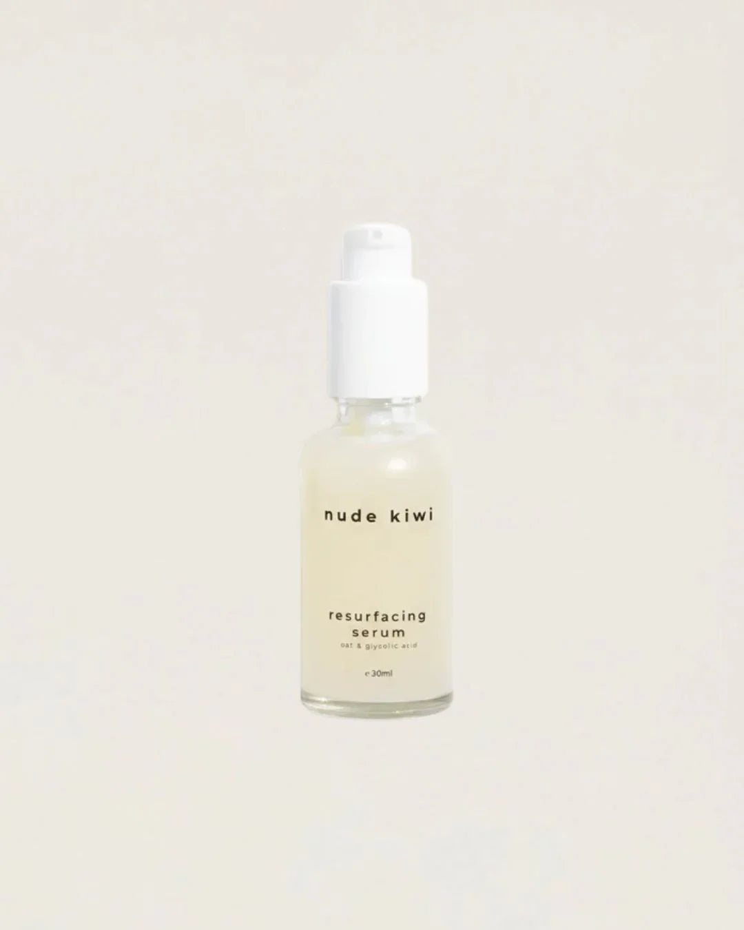 Nude Kiwi Resurfacing Serum dropper bottle with retinol and glycolic acid on a beige background