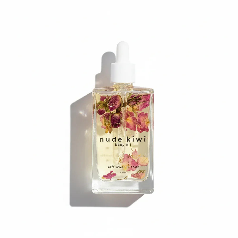 Nude Kiwi body oil bottle with floral design on a white background